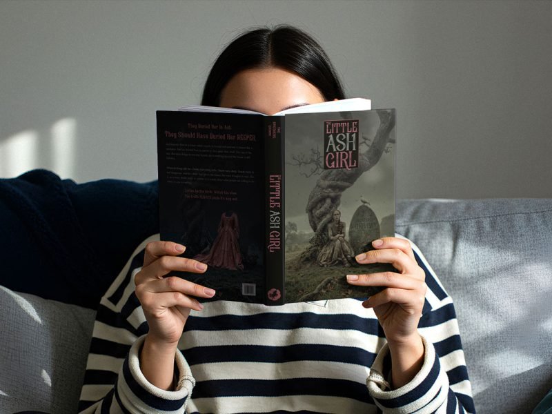 Woman holding a book open in front of her face